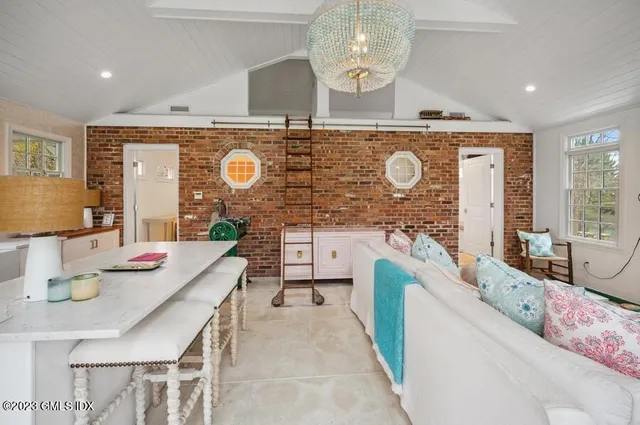 a spacious bathroom with a granite countertop double vanity sink a mirror and a bathtub