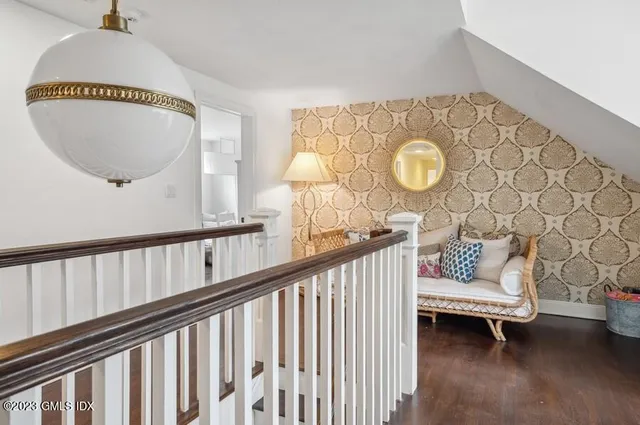 a view of a porch with furniture and wooden floor