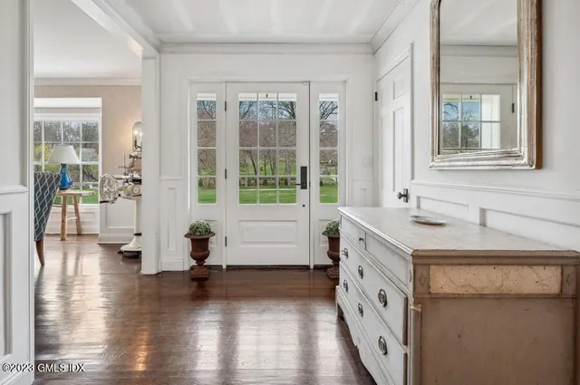 a bathroom with a sink a mirror and next to a window