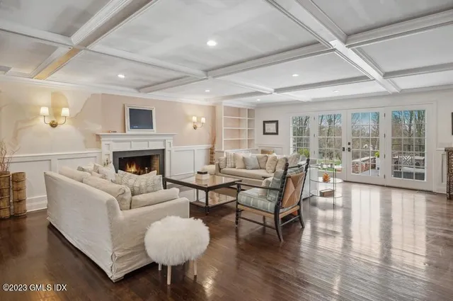 a living room with furniture a fireplace and a table