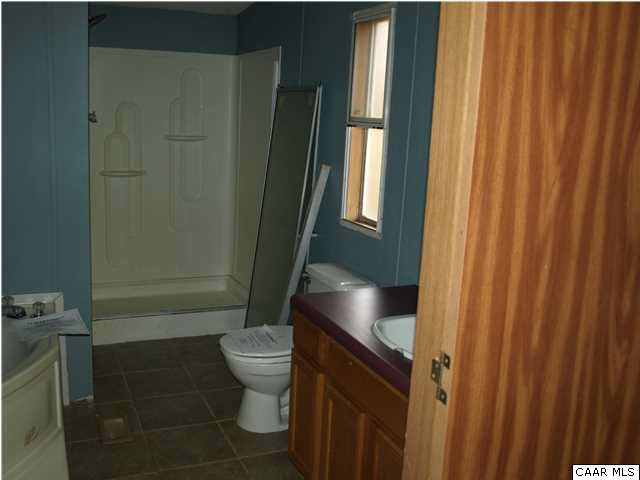 2965 Cedar Lane Road Kents Store, VA 23084 - Photo 18 of 20 a bathroom with a toilet and a shower curtain