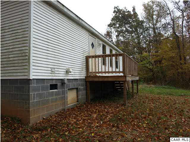 2965 Cedar Lane Road Kents Store, VA 23084 - Photo 3 of 20 a view of house with backyard and deck