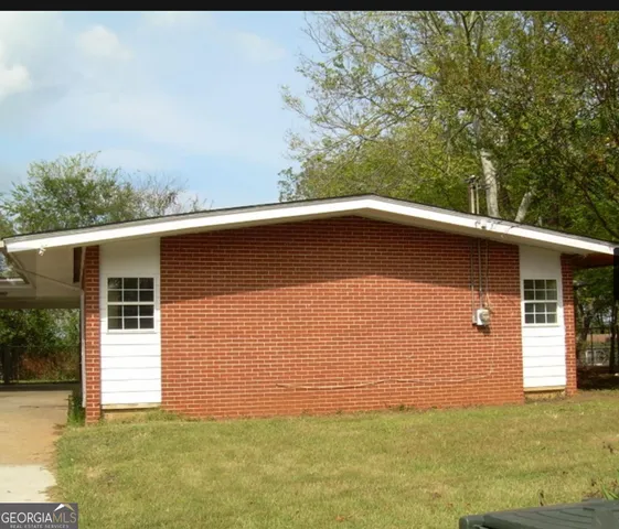 a backyard of a house with garage