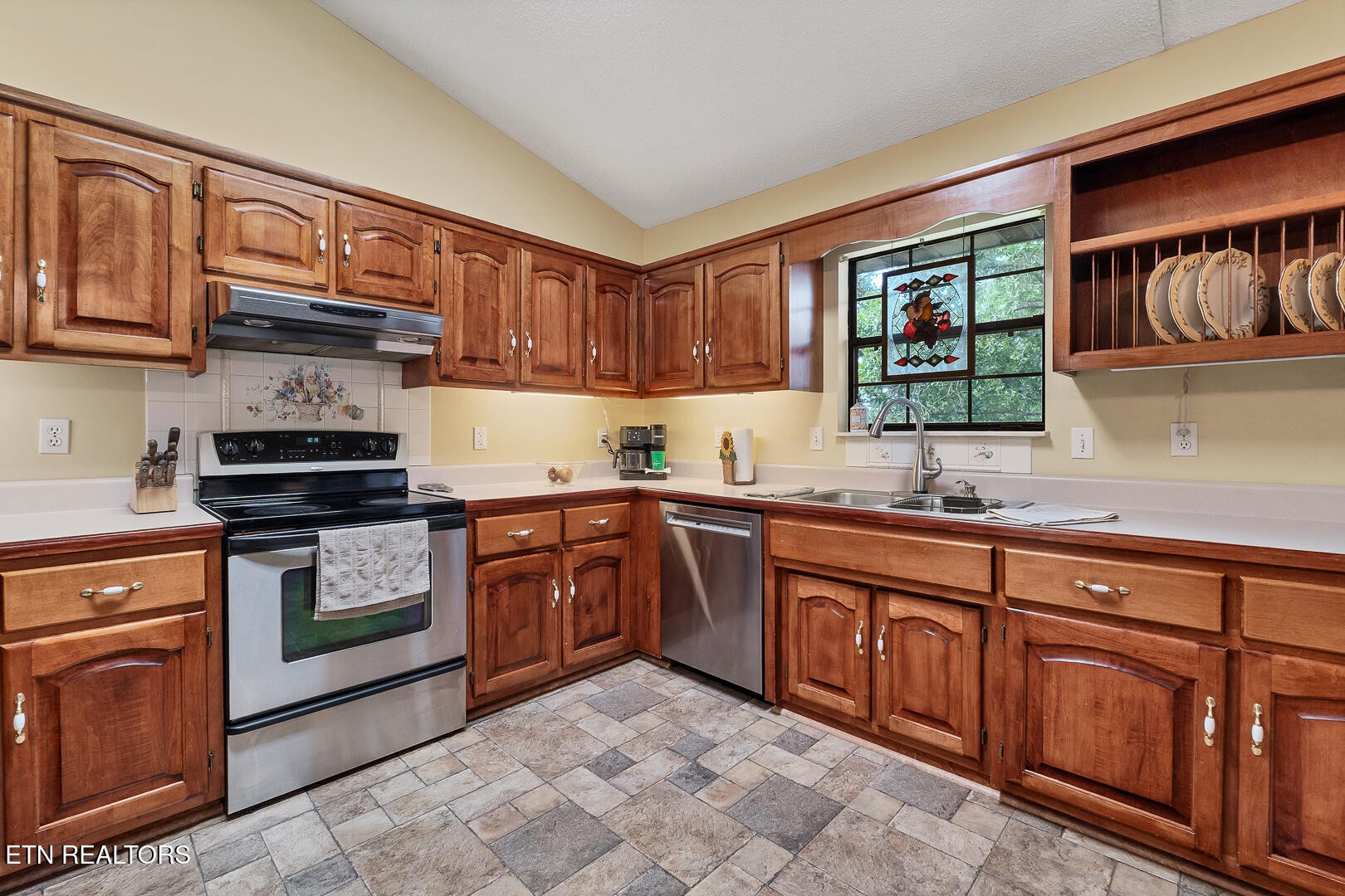 449 Foss Road Maryville, TN 37801 - Photo 20 of 49 a kitchen with granite countertop a sink dishwasher stove and cabinets