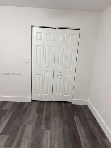 a view of room with wooden floor