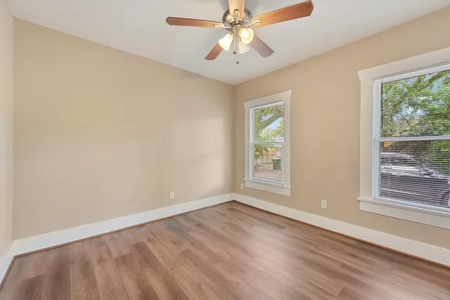 wooden floor in an empty room with a window