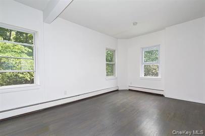 144 Union Street, Unit 6 Poughkeepsie, NY 12601 - Photo 2 of 9 an empty room with wooden floor and windows