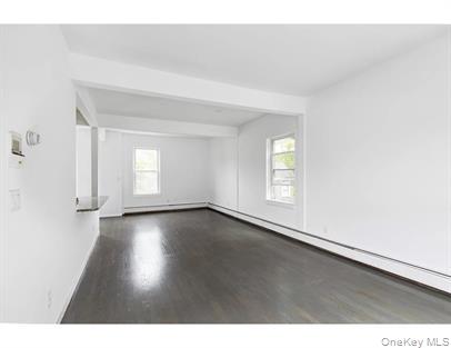 144 Union Street, Unit 6 Poughkeepsie, NY 12601 - Photo 4 of 9 a view of an empty room with wooden floor and window