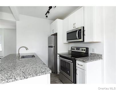 144 Union Street, Unit 6 Poughkeepsie, NY 12601 - Photo 9 of 9 a kitchen with stainless steel appliances granite countertop a sink stove and microwave