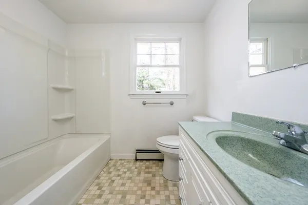 a bathroom with a sink a toilet and bathtub