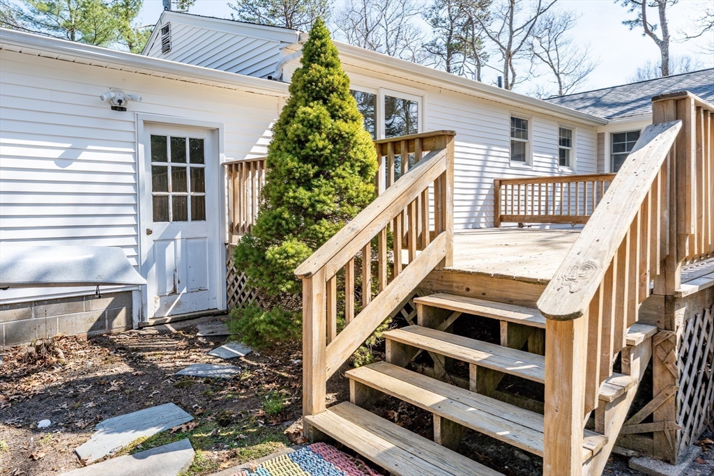 67 Crawford Road Barnstable, MA 02635 - Photo 18 of 26 a view of a house with wooden stairs and a small yard