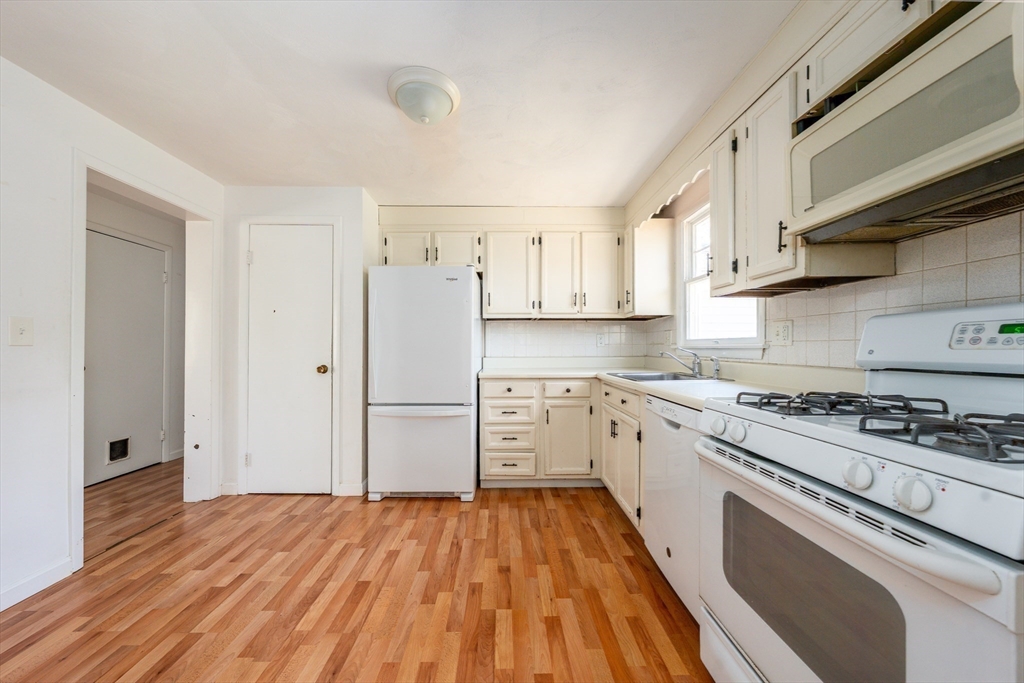 67 Crawford Road Barnstable, MA 02635 - Photo 7 of 26 a kitchen with white cabinets and stainless steel appliances