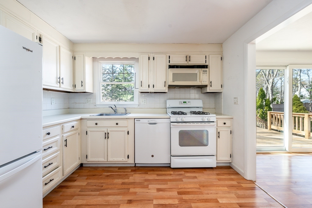 67 Crawford Road Barnstable, MA 02635 - Photo 9 of 26 a kitchen with stainless steel appliances white cabinets and a window