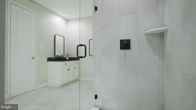 a bathroom with a shower sink and mirror