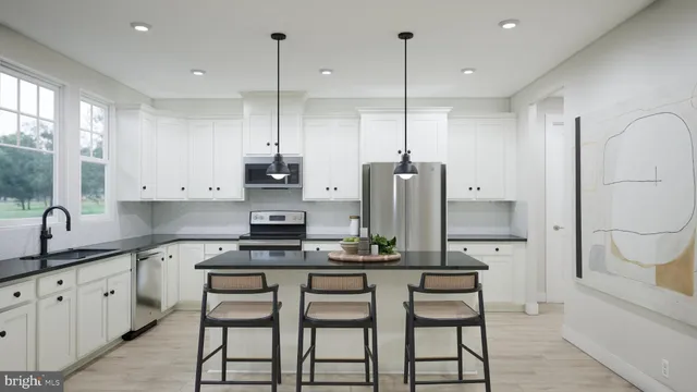 a kitchen with stainless steel appliances granite countertop a sink a stove and a refrigerator