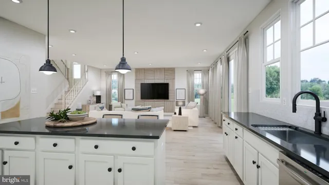 a kitchen with counter top space and living room view