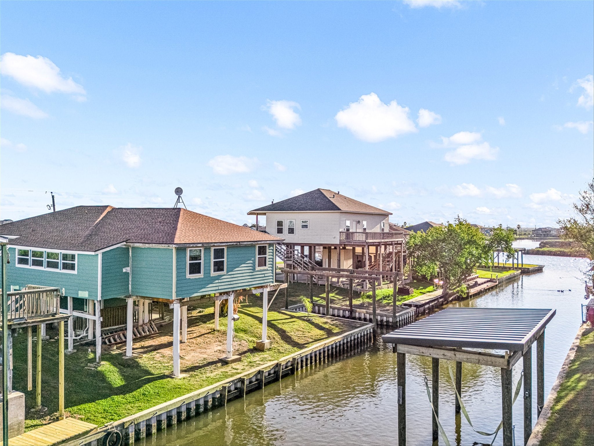 159 Garth Street Freeport, TX 77541 - Photo 11 of 42 a view of a large pool with lawn chairs under an umbrella