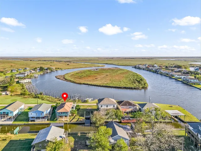 an aerial view of a house with a ocean view