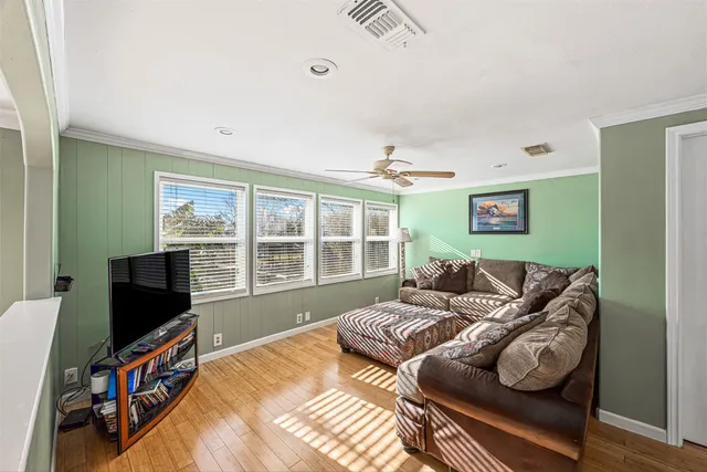 a bedroom with furniture and a flat screen tv