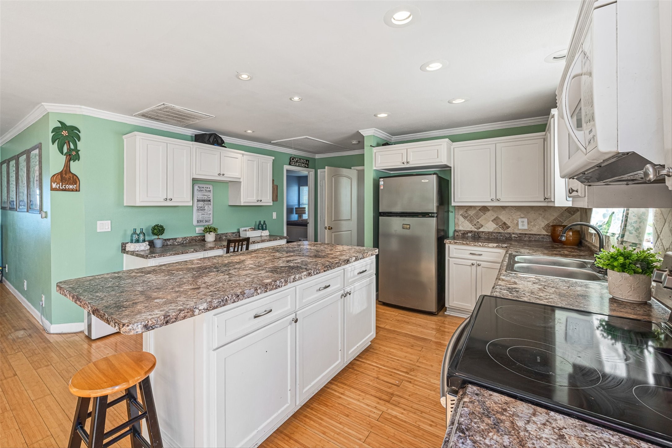 159 Garth Street Freeport, TX 77541 - Photo 23 of 42 a kitchen with stainless steel appliances granite countertop a refrigerator sink and stove