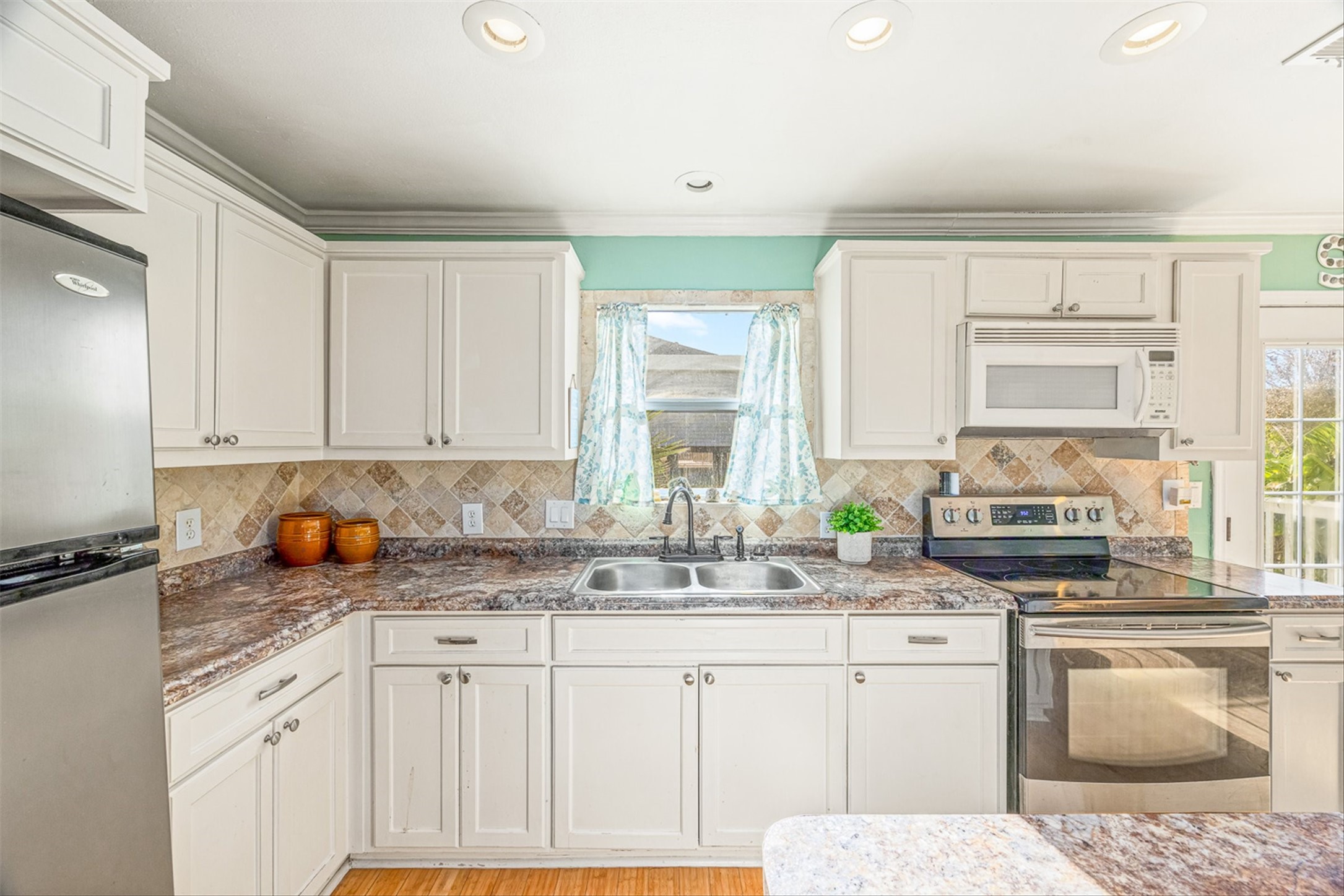 159 Garth Street Freeport, TX 77541 - Photo 24 of 42 a kitchen with stainless steel appliances granite countertop a sink stove and cabinets