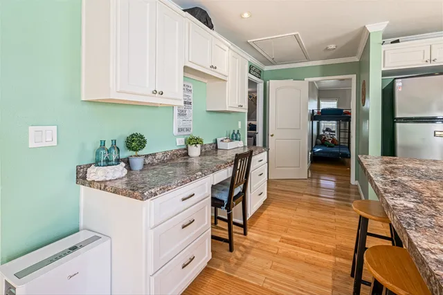 a dining hall with stainless steel appliances granite countertop a stove and a sink