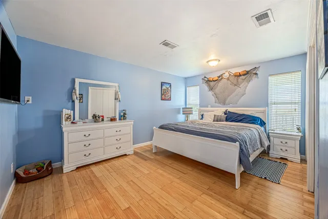 a bedroom with a bed and a mirror