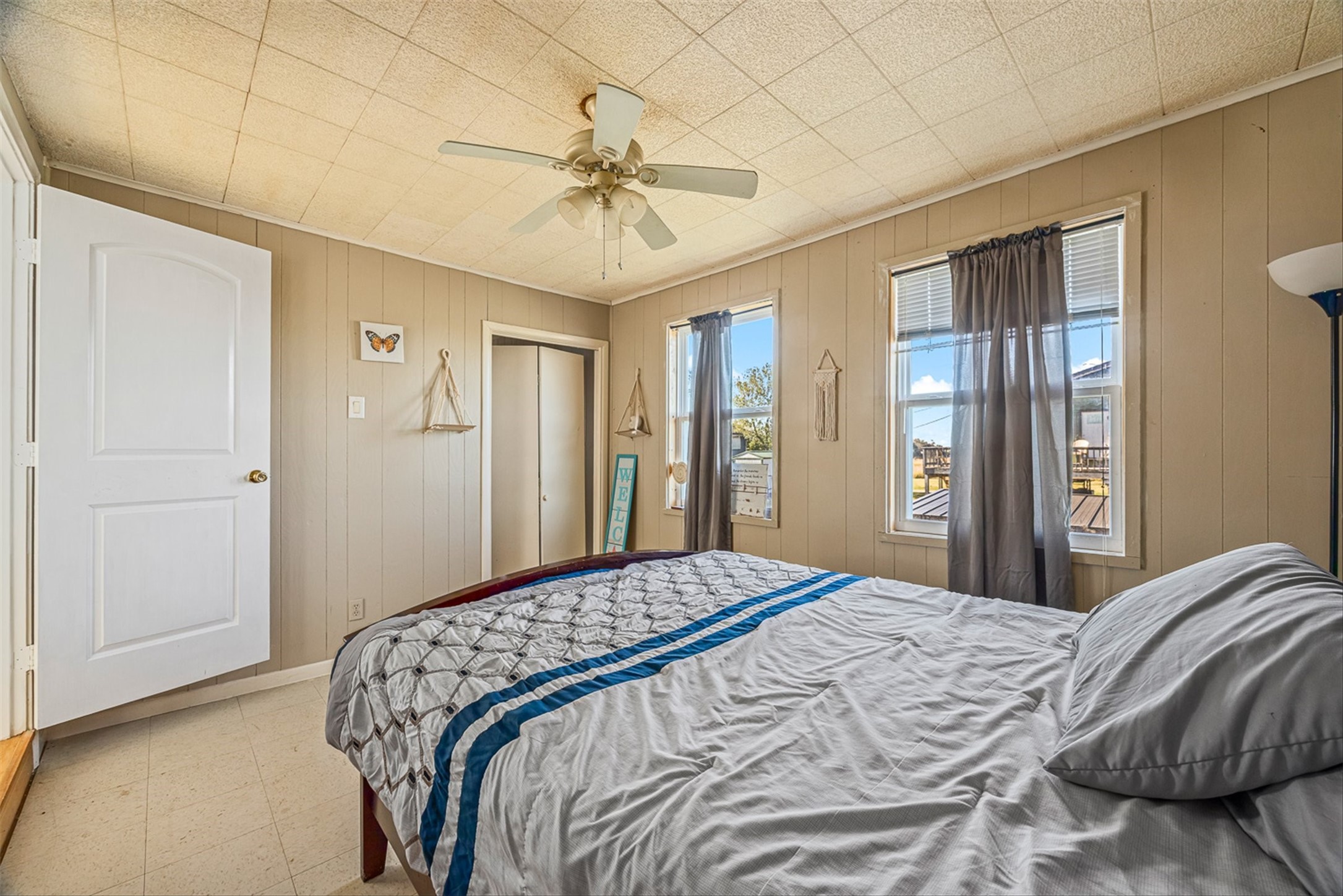 159 Garth Street Freeport, TX 77541 - Photo 41 of 42 a bedroom with a large bed and a chandelier