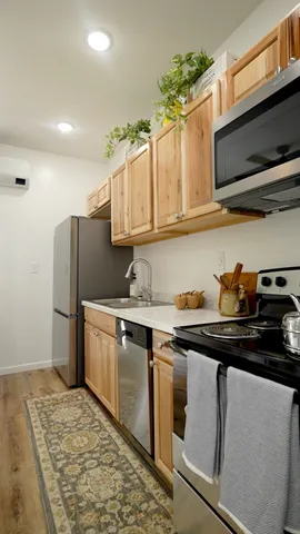 a kitchen with stainless steel appliances granite countertop a sink stove and microwave