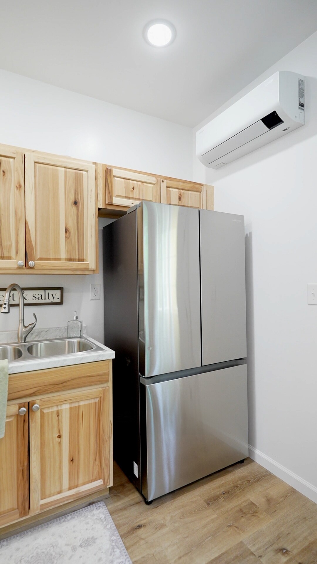 8057 Maple Street Lyles, TN 37098 - Photo 7 of 10 a kitchen with a refrigerator sink and cabinets