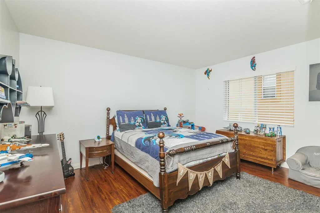 1022 Greenway Road Oceanside, CA 92057 - Photo 20 of 25 a bedroom with a bed and a table in it