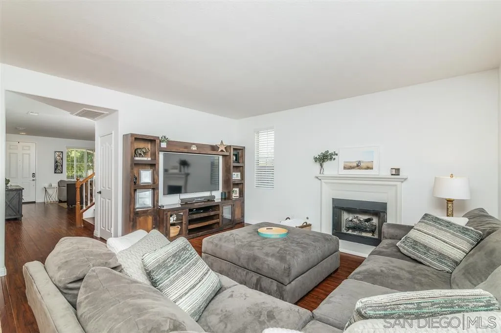 1022 Greenway Road Oceanside, CA 92057 - Photo 8 of 25 a living room with furniture a flat screen tv and a fireplace