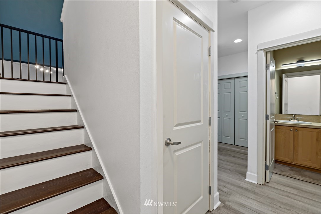 19102 20th Drive Southeast, Unit B204 Bothell, WA 98012 - Photo 16 of 30 a view of a hallway with wooden floor and staircase