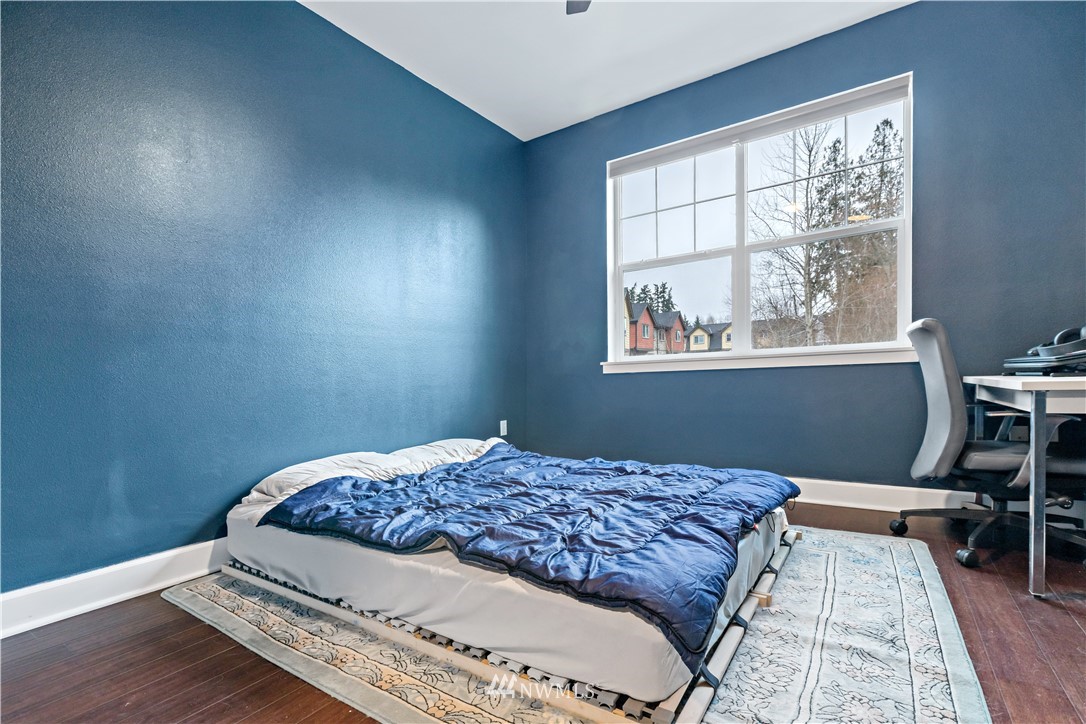 19102 20th Drive Southeast, Unit B204 Bothell, WA 98012 - Photo 17 of 30 a bedroom with a bed and a window
