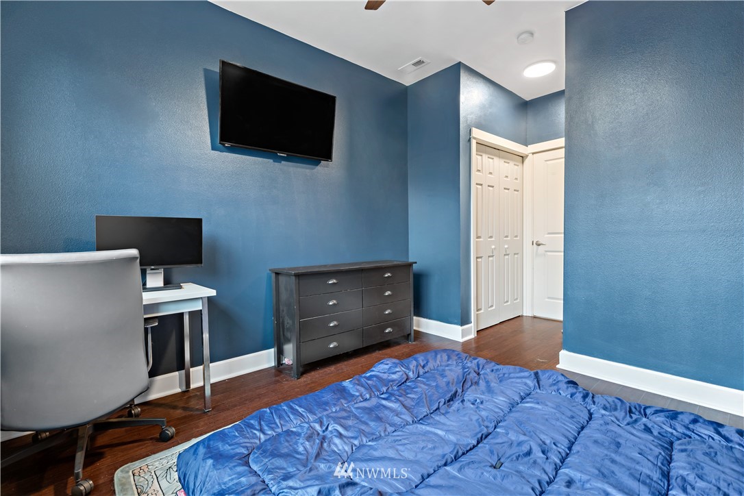 19102 20th Drive Southeast, Unit B204 Bothell, WA 98012 - Photo 18 of 30 a bedroom with a bed and a flat screen tv