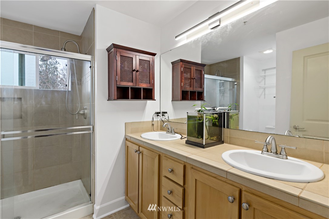 19102 20th Drive Southeast, Unit B204 Bothell, WA 98012 - Photo 19 of 30 a bathroom with double sink and a mirror