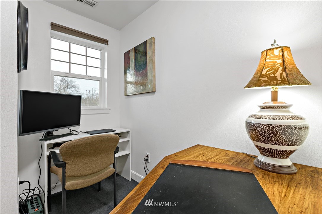 19102 20th Drive Southeast, Unit B204 Bothell, WA 98012 - Photo 21 of 30 a bedroom with a bed and a chair