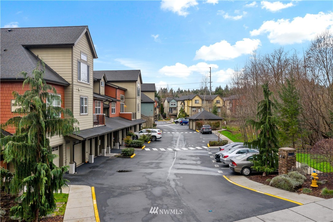 19102 20th Drive Southeast, Unit B204 Bothell, WA 98012 - Photo 25 of 30 a view of a patio with couches table and chairs potted plants and large tree