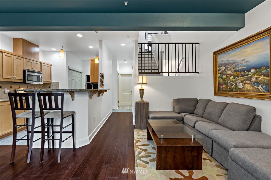 19102 20th Drive Southeast, Unit B204 Bothell, WA 98012 - Photo 8 of 30 a living room with furniture a rug and a wall painting