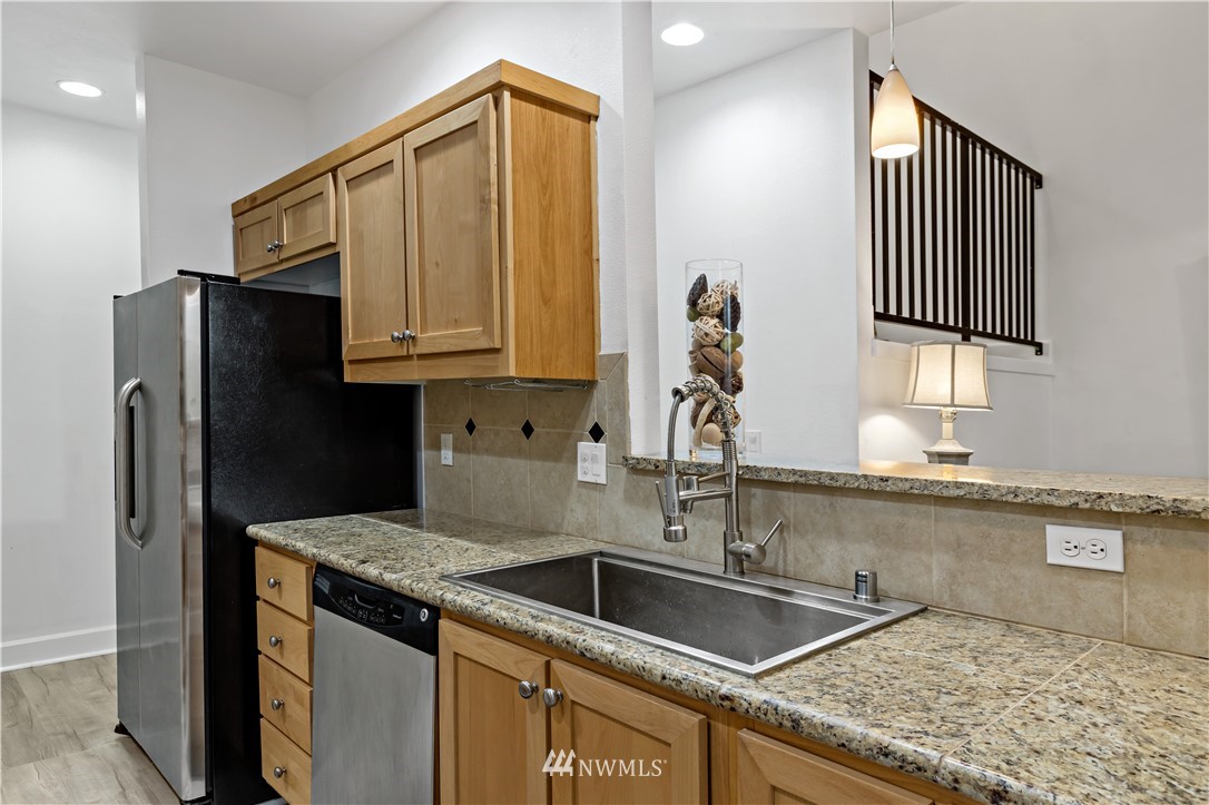 19102 20th Drive Southeast, Unit B204 Bothell, WA 98012 - Photo 10 of 30 a kitchen with stainless steel appliances granite countertop a sink stove and refrigerator