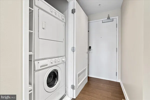 a view of a hallway with washer and dryer