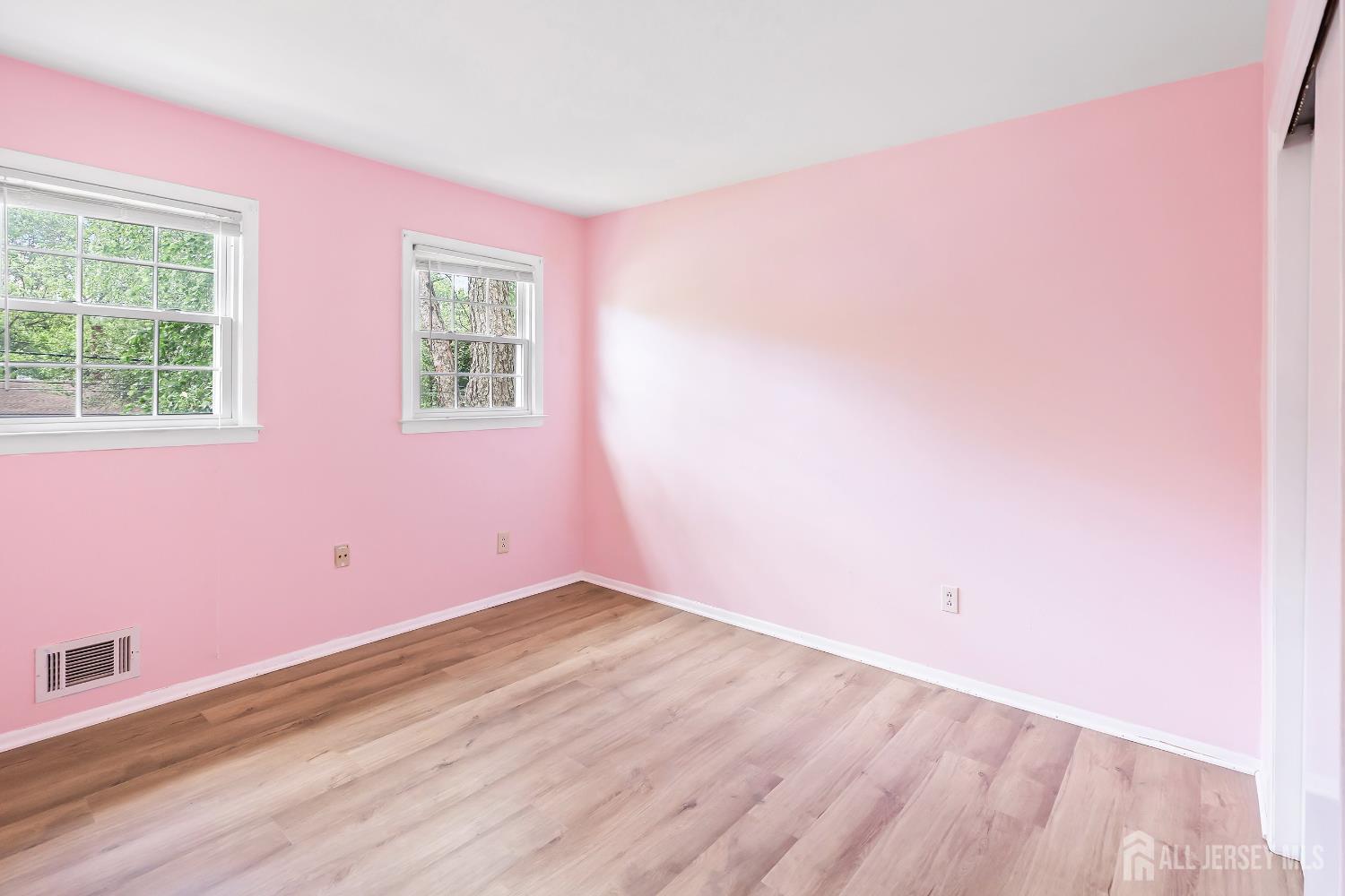 10 Woodruff Road Edison, NJ 08820 - Photo 7 of 18 an empty room with wooden floor and windows