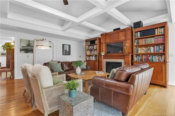 a living room with fireplace furniture and a book shelf