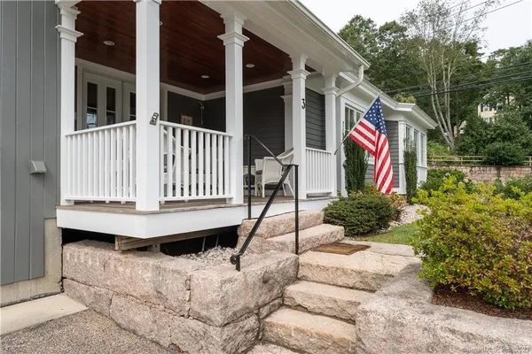 a front view of a house with a yard and porch