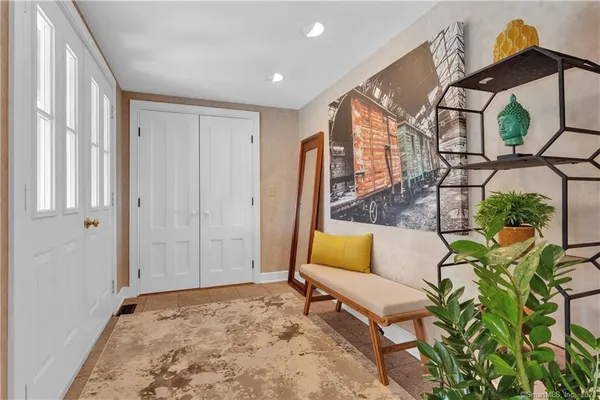 a view of a house with a yard and sitting area