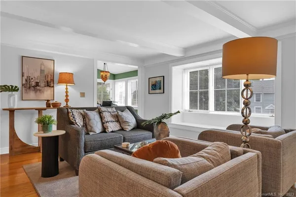 a kitchen with stainless steel appliances a sink a stove a refrigerator cabinets and a dining table
