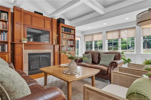 a living room with furniture a fireplace and a large window