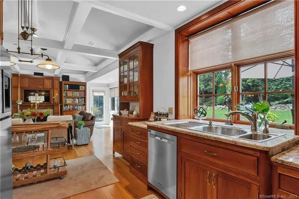 a open kitchen with stainless steel appliances granite countertop sink stove and wooden cabinets