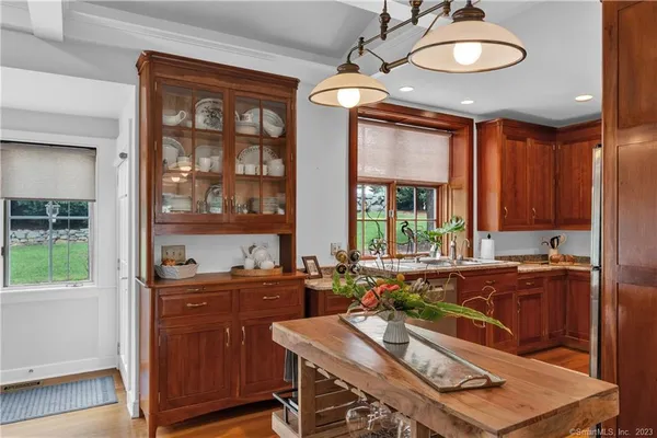 a room with a table chairs and wooden floor