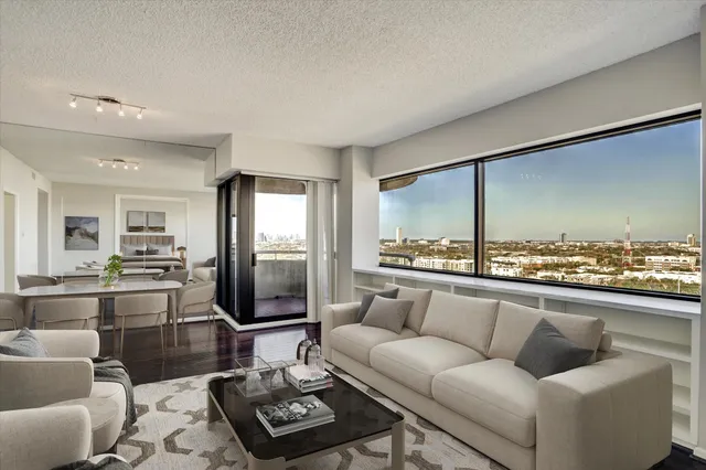 a living room with furniture and a floor to ceiling window